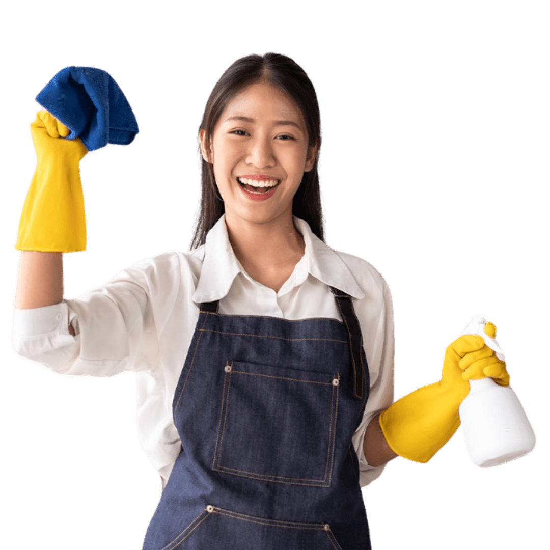 A smiling woman in a white shirt and apron, working for a janitorial service, wears yellow gloves and holds a spray bottle in one hand and a blue cleaning cloth in the other.